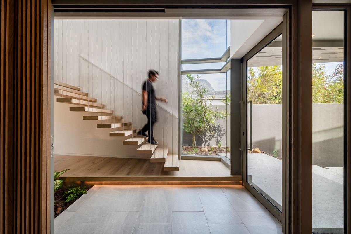 Staircase connecting the Prima Vista Penthouse's two floors at Riva One
