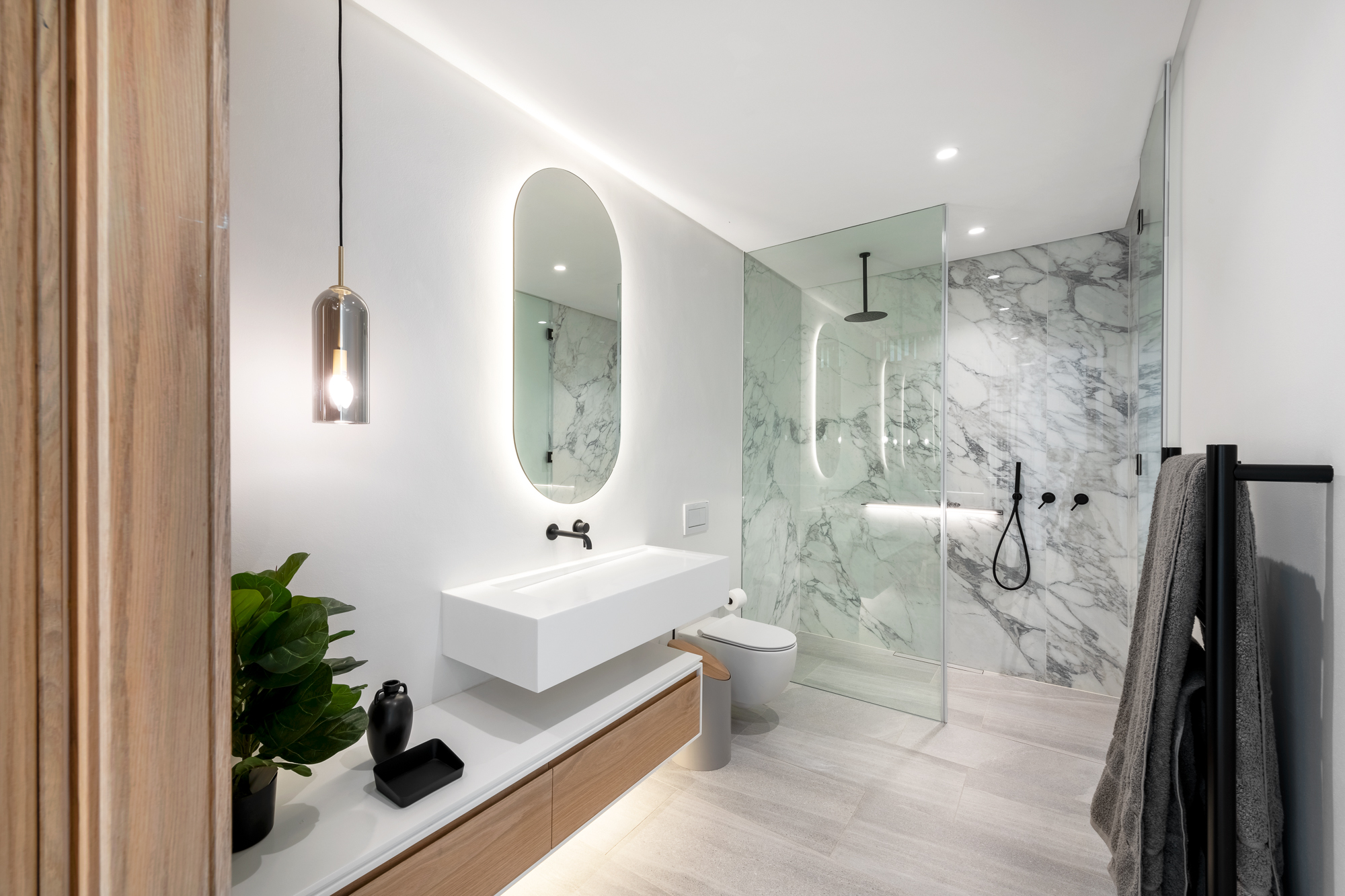 Luna Suite en-suite bathroom with backlit mirror and walk-in glass shower – Riva One, Camps Bay