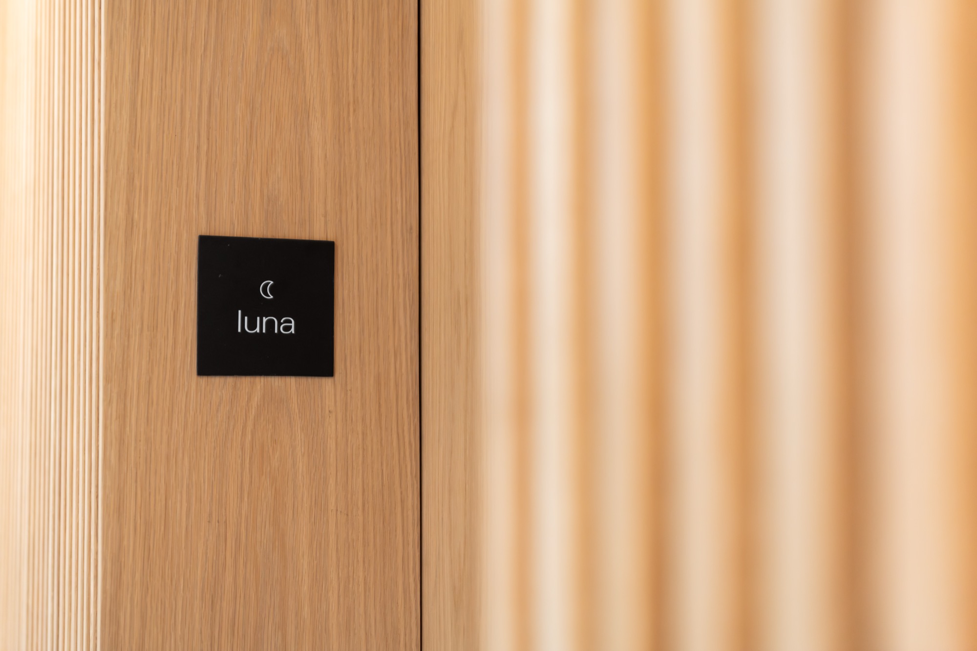 Luna Suite door signage with crescent-moon icon – Riva One, Camps Bay