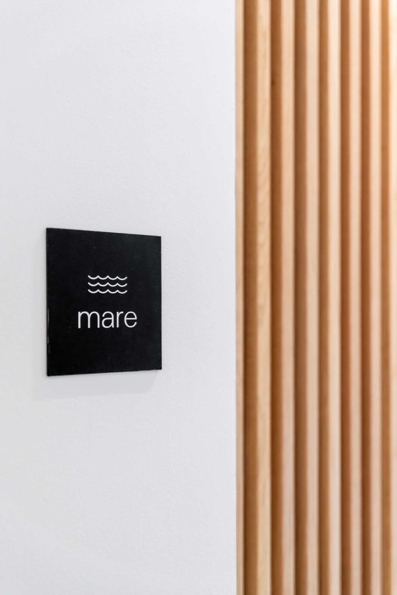 Mare Suite door signage with wave icon – Riva One, Camps Bay