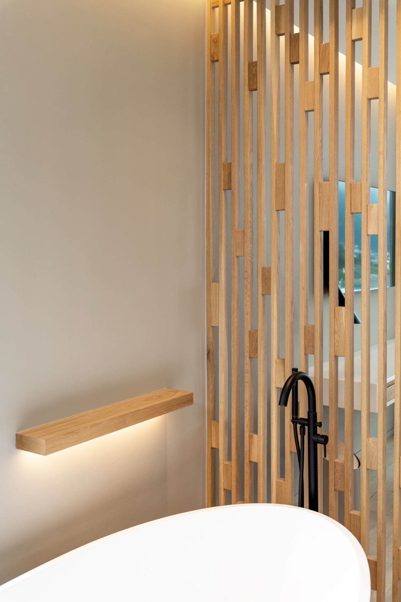 Mare Suite bathroom detail with wood shelf light and freestanding tub – Riva One, Camps Bay