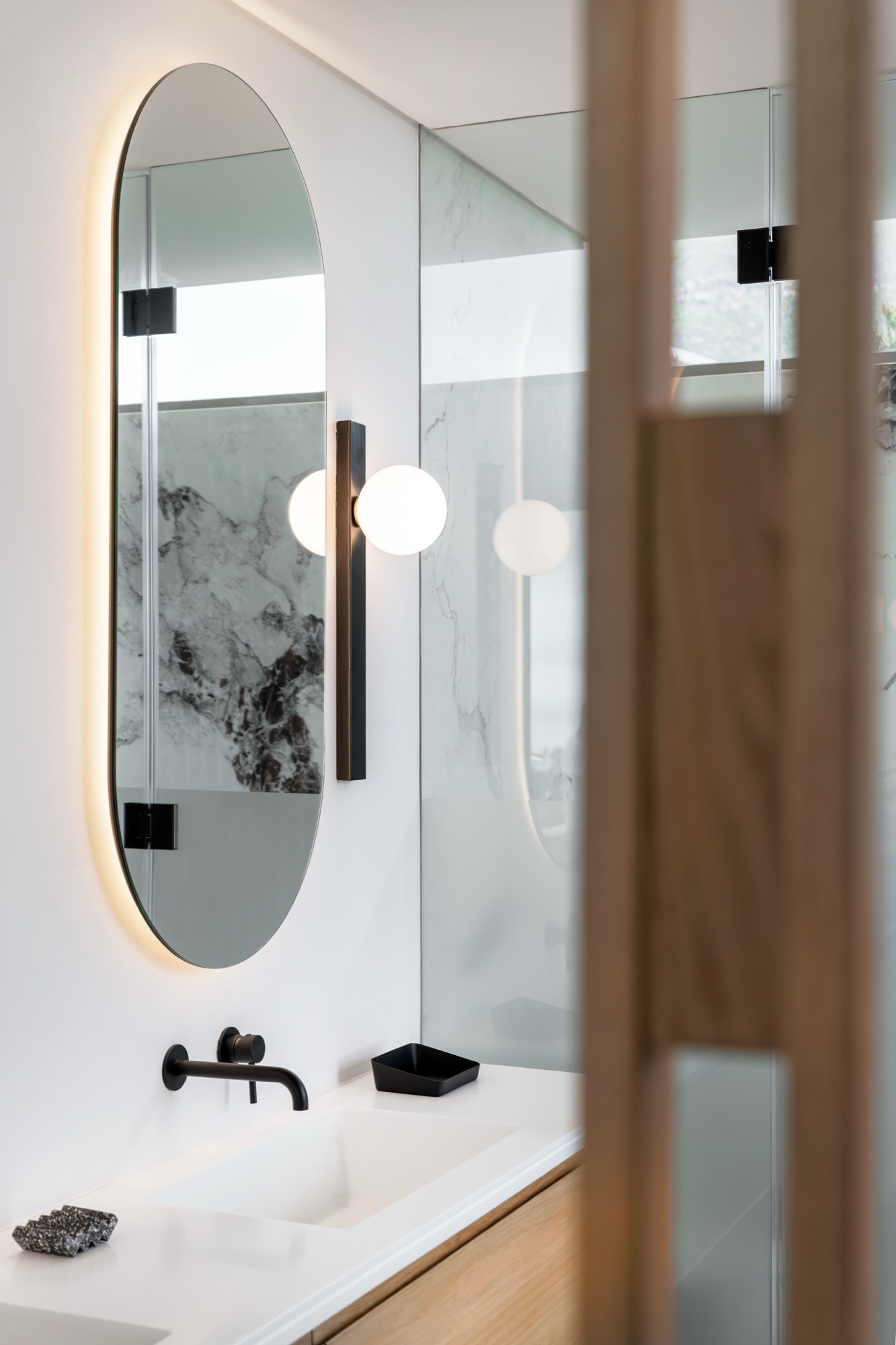 Mare Suite vanity with backlit mirror and marble walls – Riva One, Camps Bay