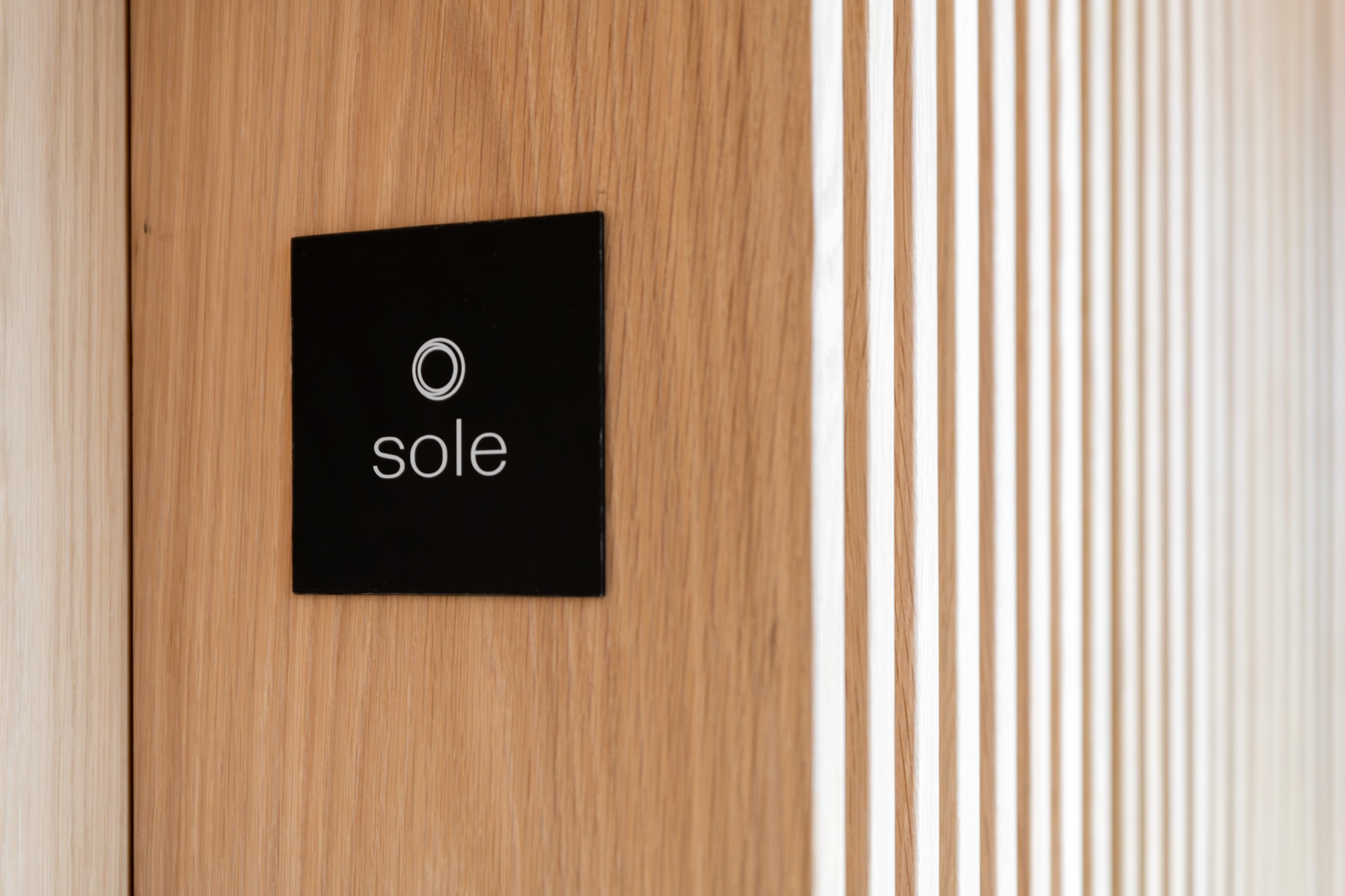 Sole Suite door signage with sun icon – Riva One, Camps Bay